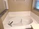 Bright bathroom featuring a soaking tub with tile surround and modern fixtures at 500 Wellesly St, Oviedo, FL 32765