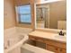 Relaxing bathroom featuring a soaking tub, vanity with sink, and large mirror at 500 Wellesly St, Oviedo, FL 32765