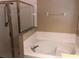 Bright bathroom featuring a large soaking tub with tile surround and a glass-enclosed shower at 500 Wellesly St, Oviedo, FL 32765