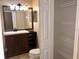 Bathroom with vanity, toilet, mirror, and built-in shelves at 500 Wellesly St, Oviedo, FL 32765