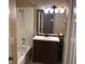 Bathroom with a tub, shower, vanity, and mirror at 500 Wellesly St, Oviedo, FL 32765