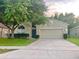 Charming single-story home with a well-manicured front lawn and attached two-car garage at 500 Wellesly St, Oviedo, FL 32765