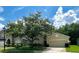 Single-Gathering home with a well-manicured lawn and mature tree in the front yard at 500 Wellesly St, Oviedo, FL 32765