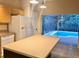 Kitchen featuring a spacious island and stainless steel appliances, opening to the screened-in patio and pool at 500 Wellesly St, Oviedo, FL 32765