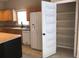 Kitchen featuring light wood cabinets, a stainless steel refrigerator, and a walk-in pantry at 500 Wellesly St, Oviedo, FL 32765