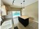 Bright kitchen view to island with light countertop and a backyard view through the sliding door at 500 Wellesly St, Oviedo, FL 32765