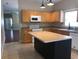 Kitchen with light wood cabinets, stainless steel appliances, and an island with a countertop at 500 Wellesly St, Oviedo, FL 32765