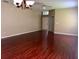 Open-concept living room featuring shiny wood floors and front door access at 500 Wellesly St, Oviedo, FL 32765