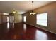 Open-plan living room with hardwood floors and multiple windows at 500 Wellesly St, Oviedo, FL 32765
