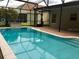 Outdoor pool with covered lanai and serene backyard view at 500 Wellesly St, Oviedo, FL 32765