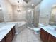 Bathroom with double sinks, soaking tub, and glass enclosed shower at 506 Terrace Spring Dr, Orlando, FL 32828