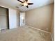 Bedroom with neutral carpet and ceiling fan, adjacent to a closet at 506 Terrace Spring Dr, Orlando, FL 32828