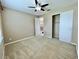Neutral bedroom featuring carpet, ceiling fan and closet with views to the loft at 506 Terrace Spring Dr, Orlando, FL 32828