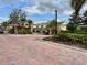 Gated community entrance with brick paver road and lush landscaping at 506 Terrace Spring Dr, Orlando, FL 32828