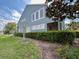 Home with a screened patio, lush lawn, and mature landscaping at 506 Terrace Spring Dr, Orlando, FL 32828