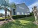 Two-story home featuring a blue exterior, well-maintained lawn, and manicured hedges at 506 Terrace Spring Dr, Orlando, FL 32828