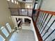 Spacious foyer with tiled floors, chandelier, and wrought iron staircase overlooking kitchen at 506 Terrace Spring Dr, Orlando, FL 32828