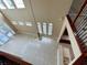 Open foyer with tile flooring, chandelier, and wrought iron staircase at 506 Terrace Spring Dr, Orlando, FL 32828
