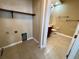Laundry room featuring tile floor, shelving, and washer hookups at 506 Terrace Spring Dr, Orlando, FL 32828