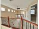 Cozy loft featuring neutral paint, carpet, and a railing overlooking the floor below at 506 Terrace Spring Dr, Orlando, FL 32828