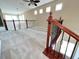 Open loft area with neutral carpet, natural light, and decorative staircase railing at 506 Terrace Spring Dr, Orlando, FL 32828