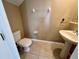 Well-lit powder room with a pedestal sink and neutral tones at 506 Terrace Spring Dr, Orlando, FL 32828