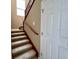 Carpeted staircase with wooden handrail leading to the upper level at 506 Terrace Spring Dr, Orlando, FL 32828