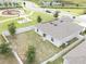 Aerial view of backyard, the home's roof with solar panels, and nearby pond at 561 Andrea S Cir, Haines City, FL 33844