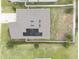 Aerial view shows the home's roof with solar panels and fenced in yard at 561 Andrea S Cir, Haines City, FL 33844