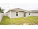 Backyard featuring green grass, a privacy fence and a sliding glass door at 561 Andrea S Cir, Haines City, FL 33844