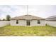 Backyard featuring green grass, a privacy fence and a sliding glass door at 561 Andrea S Cir, Haines City, FL 33844