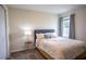 Cozy bedroom featuring a comfortable bed, soft lighting, and a window offering a serene view of outdoors at 561 Andrea S Cir, Haines City, FL 33844