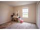 Well-lit bedroom featuring a vanity with lighted mirror, plush carpet, and a window overlooking the outdoors at 561 Andrea S Cir, Haines City, FL 33844