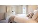 Bright bedroom featuring a plush bed, dresser with mirror, and natural light from the window at 561 Andrea S Cir, Haines City, FL 33844