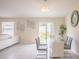 Dining area open to the living room, with modern decor, tile floors, and sliding doors to the backyard at 561 Andrea S Cir, Haines City, FL 33844
