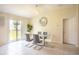 Bright dining room with a modern table, stylish chairs, a decorative mirror, and sliding glass doors at 561 Andrea S Cir, Haines City, FL 33844