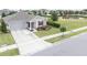Charming single-story home with well-manicured lawn, gray siding, a red front door and playground nearby at 561 Andrea S Cir, Haines City, FL 33844
