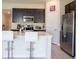 Modern kitchen with stainless steel appliances, a breakfast bar, and sleek countertops at 561 Andrea S Cir, Haines City, FL 33844