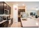 Modern kitchen featuring dark cabinetry, stainless steel appliances, and a large center island at 561 Andrea S Cir, Haines City, FL 33844