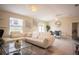 Bright living room with a large white couch and glass coffee table, perfect for relaxing and entertaining guests at 561 Andrea S Cir, Haines City, FL 33844