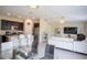 Open-concept living space with the dining room, white sofa, stainless fridge and breakfast bar at 561 Andrea S Cir, Haines City, FL 33844