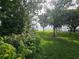 Expansive lawn with mature trees and access to the lake and dock, great for outdoor activities at 606 Butler St, Windermere, FL 34786