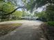 Long driveway leading to a charming home surrounded by mature trees at 606 Butler St, Windermere, FL 34786