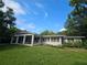 Rear exterior featuring a covered patio and well-maintained lawn at 606 Butler St, Windermere, FL 34786