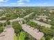 Expansive aerial view showcasing a residential neighborhood surrounded by lush greenery and community amenities at 6453 Alcalde Ct # 110, Orlando, FL 32835