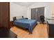 Comfortable bedroom featuring a large bed, wood floors, and a neutral color scheme at 6453 Alcalde Ct # 110, Orlando, FL 32835