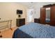 Well-lit bedroom with a bed, wood floors, and ample storage space at 6453 Alcalde Ct # 110, Orlando, FL 32835