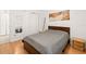 Neutral bedroom with wood floors, mirrored closet doors, and natural lighting at 6453 Alcalde Ct # 110, Orlando, FL 32835