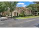 Attractive townhome displaying a two-car garage, trimmed bushes, and a clear street view at 6453 Alcalde Ct # 110, Orlando, FL 32835