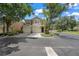 Inviting townhome showcasing a two-car garage, neat landscaping, and a peaceful neighborhood setting at 6453 Alcalde Ct # 110, Orlando, FL 32835